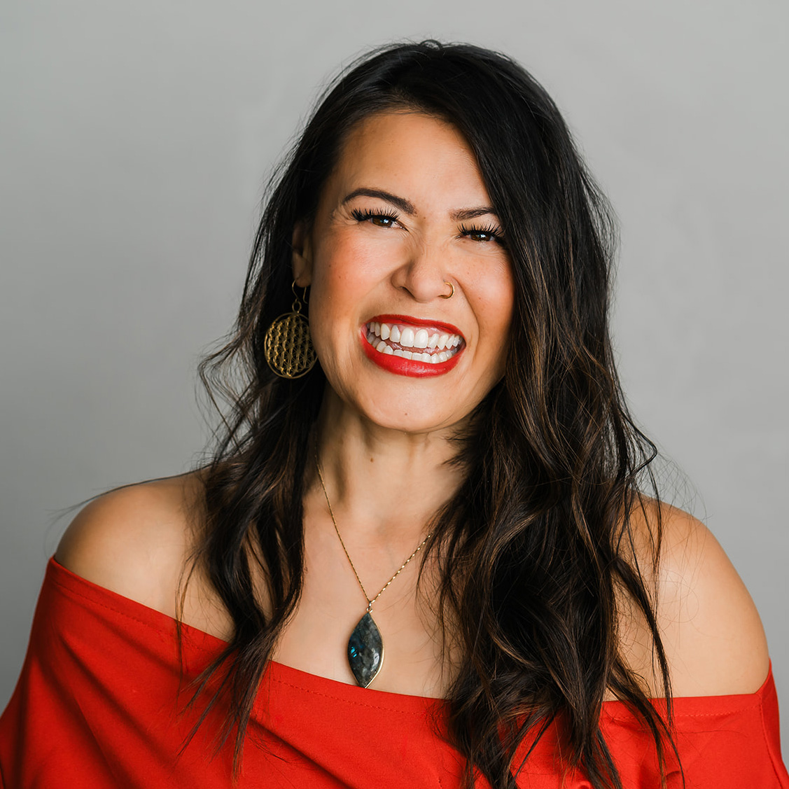 Headshot of an Edmonton business coach wearing red in a blog article for how to prepare for headshots