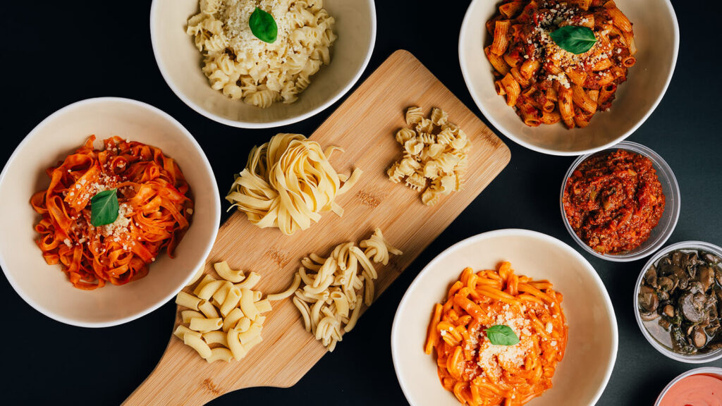 A carefully arranged overhead shot of different from scratch pasta and sauces for a local Edmonton restaurant for their food menu